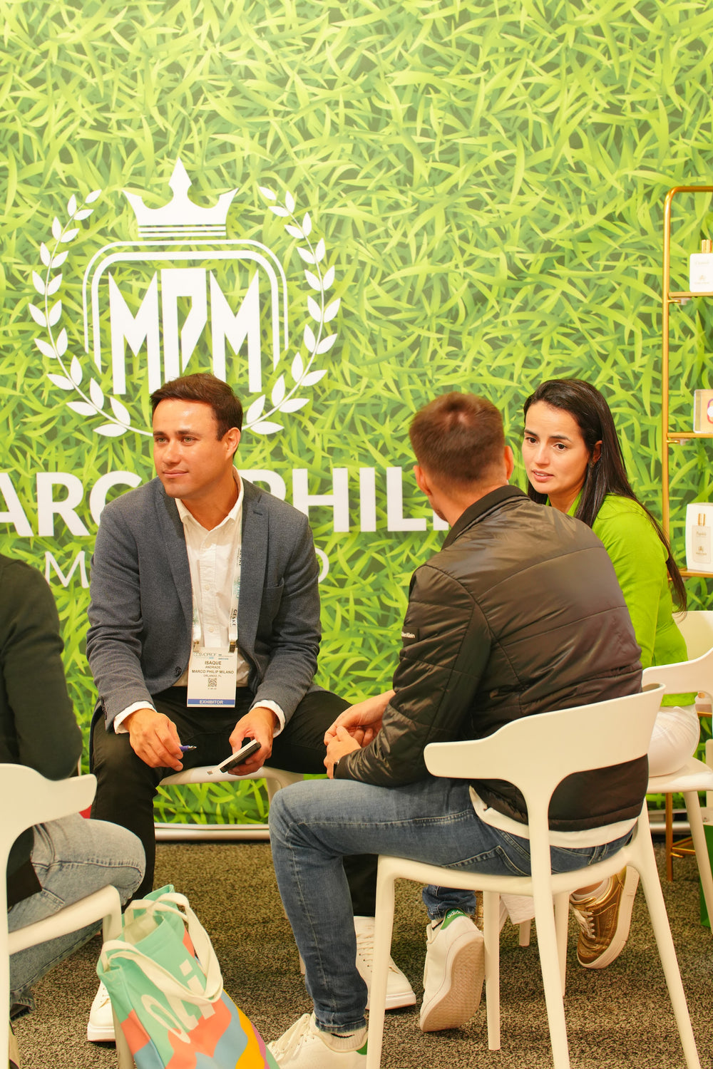 A conversation at the Marco Philip Milano booth, in front of the crest wall